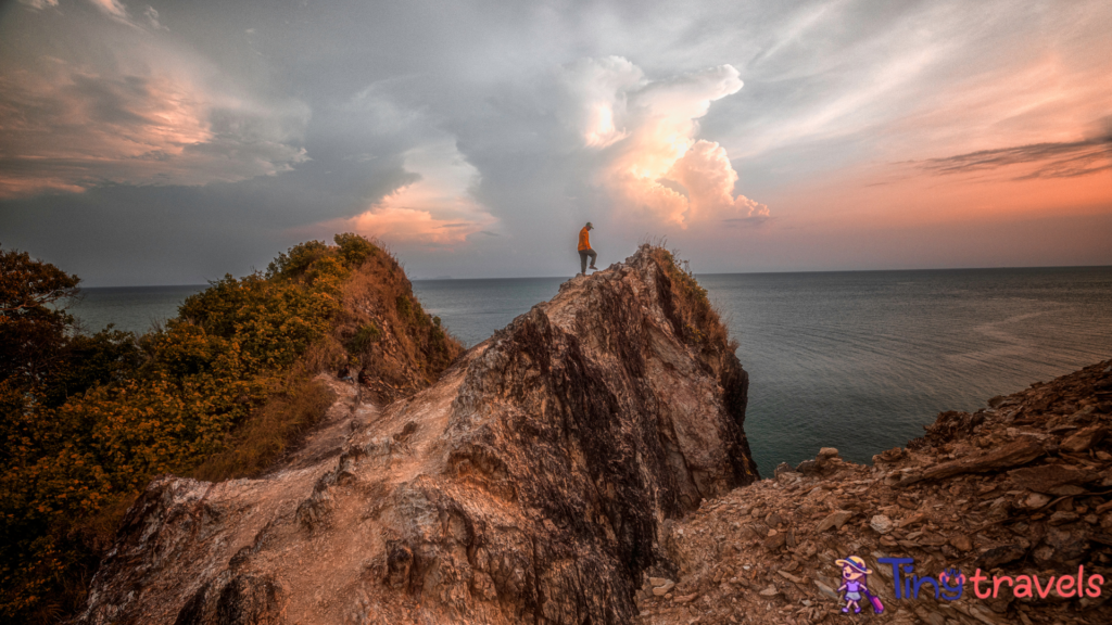 A man walk step by step on the sea cliff in sunset at Nation park of koh Lanta,Krabi, Thailand⁠