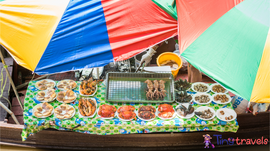 Floating food stall with seafood at Amphawa Floating Market⁠