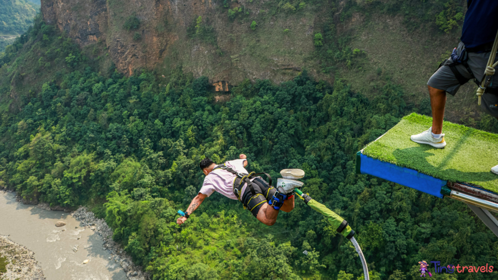 A man is jumping off a cliff into a river⁠