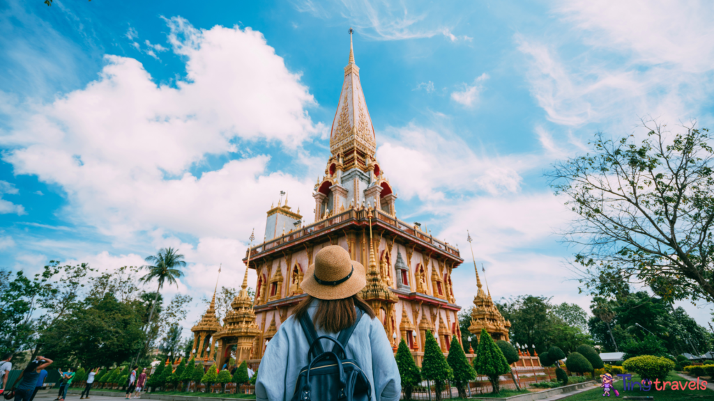 Young woman traveler with backpack traveling into beautiful pagoda in Wat Chalong or Chalong temple at Phuket town, Thailand. It's most popular thai temple in Phuket Thailand.⁠