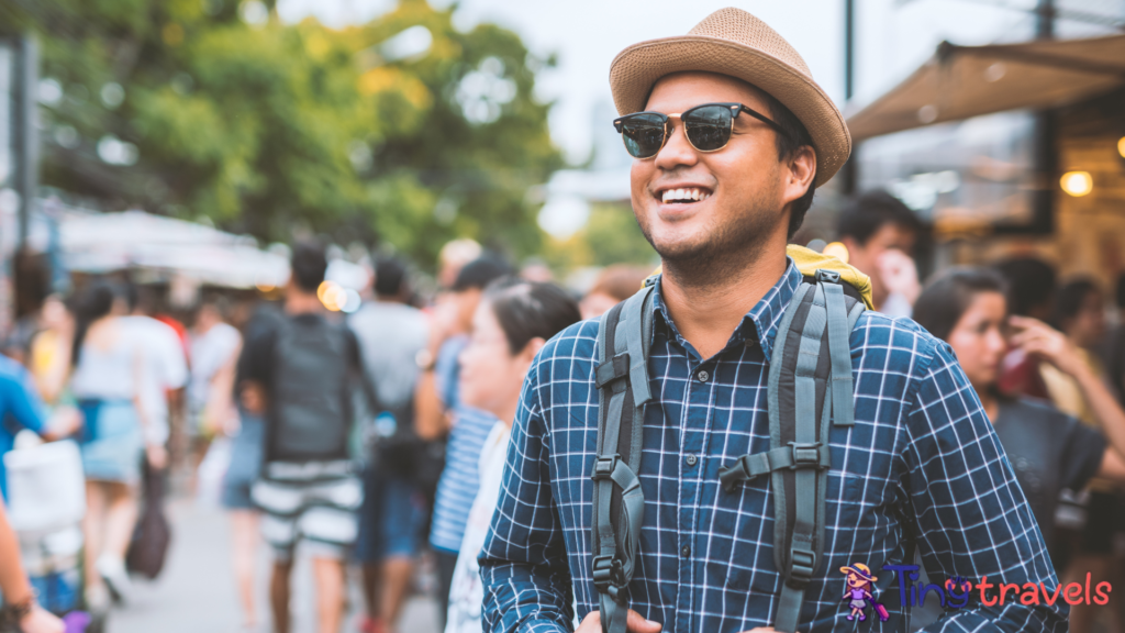 Traveling man walking at Chatuchak Market in Bangkok Thailand.⁠