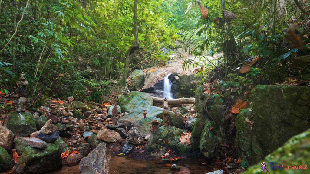 Kathu waterfall water gently flowing down the rocks Patong Phuket Thailand Asia⁠