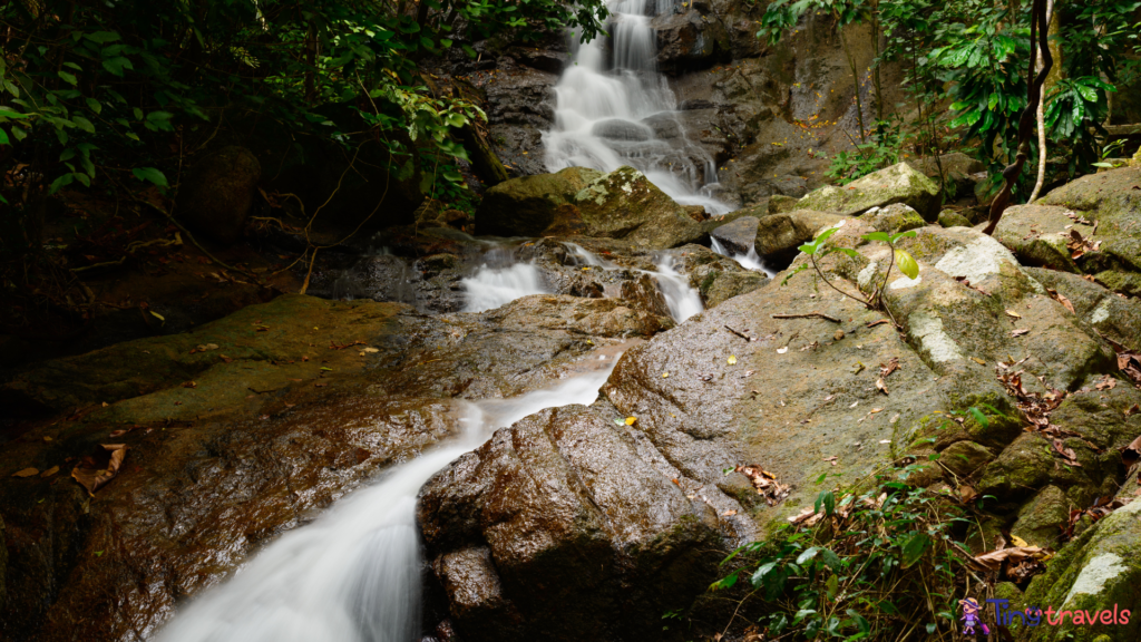 Kathu waterfall water gently flowing down the rocks Patong Phuket Thailand Asia⁠