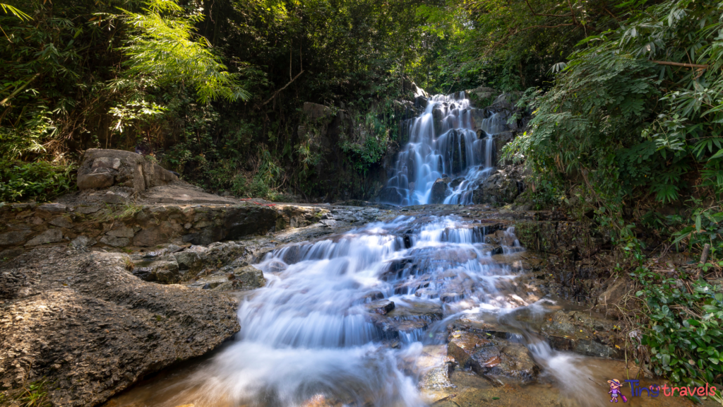 Kathu waterfall water gently flowing down the rocks Patong Phuket Thailand Asia⁠